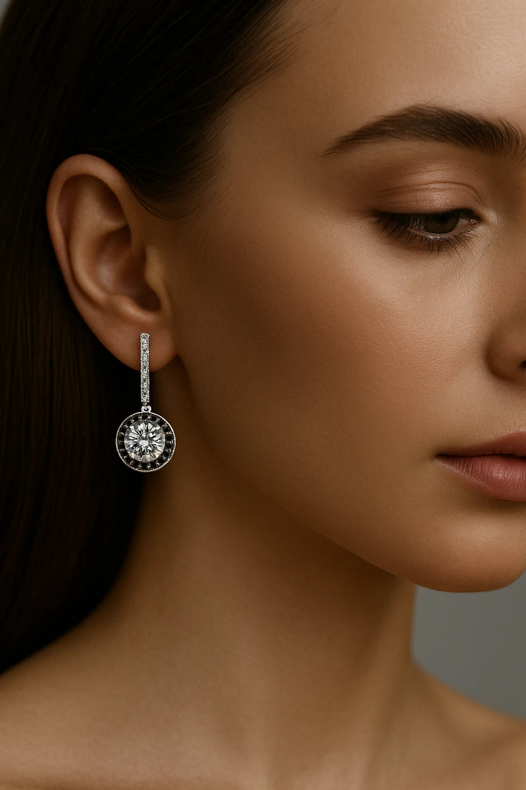 A close-up of a person wearing heart-shaped turquoise earrings, showcasing their elegant design and shimmering details.