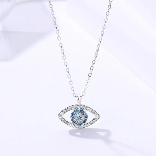 Silver chain necklace featuring an eye-shaped pendant with blue and white gemstones, symbolizing protection and elegance.