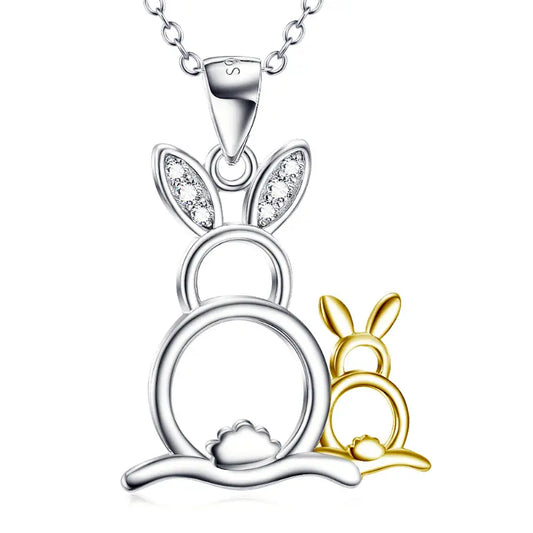 A silver rabbit necklace with sparkling ears, featuring a smaller golden rabbit and a round base design, symbolizing charm and whimsy.