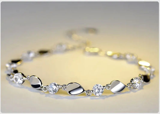 Elegant silver bracelet featuring alternating smooth oval and circular shapes, resting on a light background. Ideal for casual or formal wear.