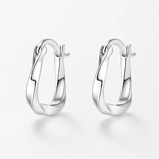 Pair of silver hoop earrings on a light gray background