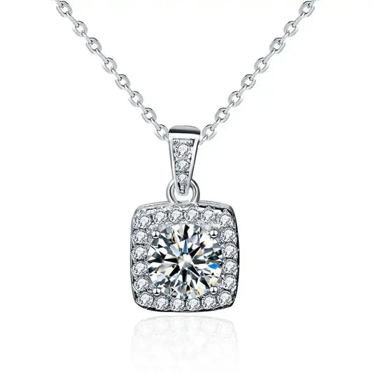 A sparkling square pendant necklace featuring a large central diamond surrounded by smaller stones, set in a silver chain.